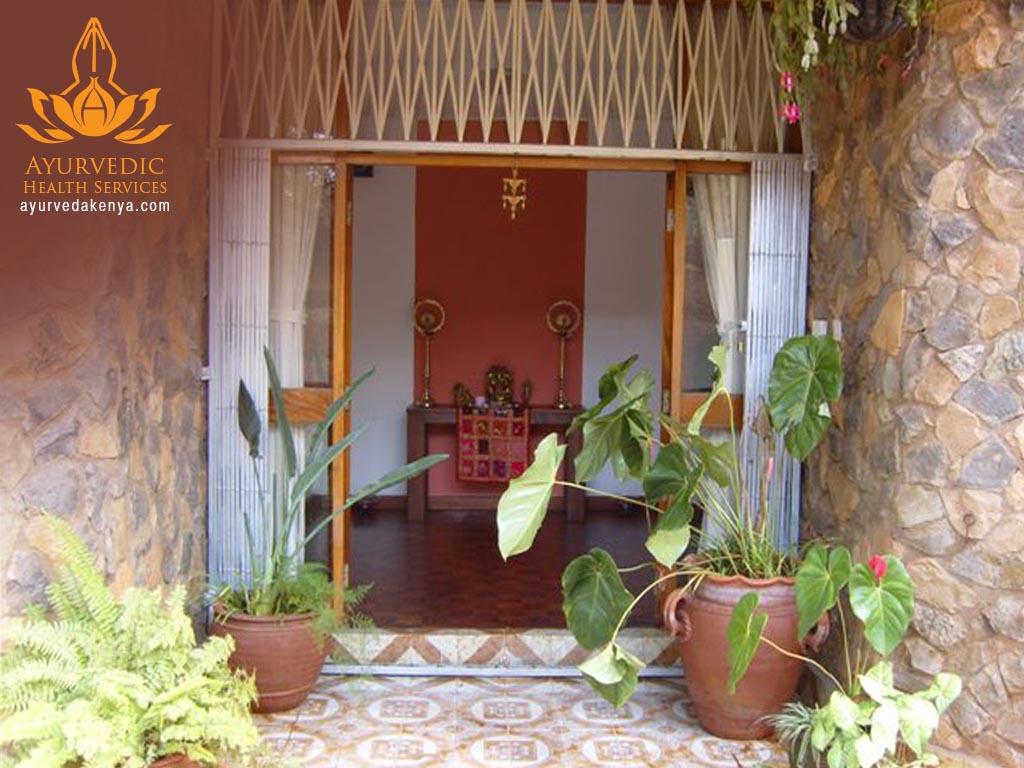 The entrance to the Ayurveda Kenya clinic, framed by tropical plants